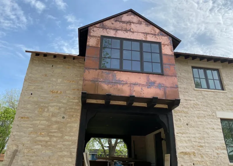 Copper metal panel facade on a stone building for Skylight Installation in Texarkana